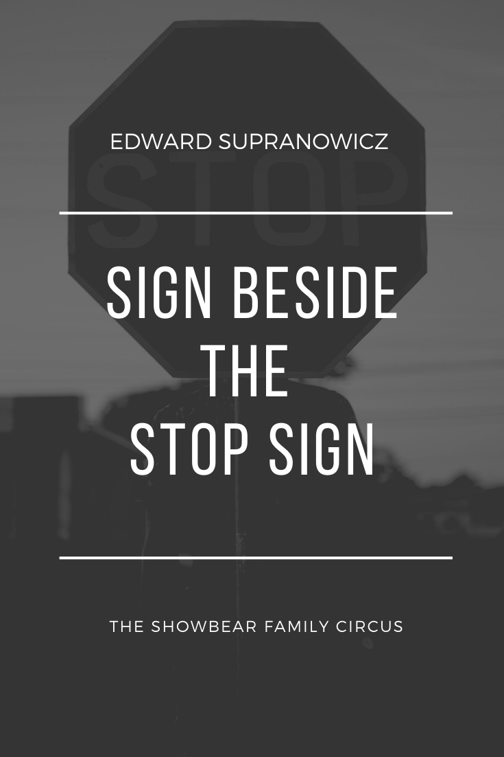 Sign Beside the Stop Sign